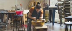 A woman is working in a pottery studio.