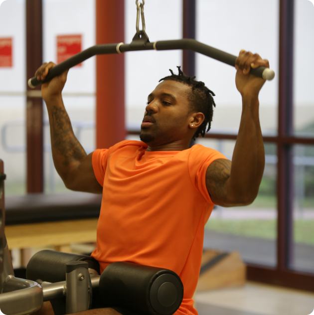 A man lifting weights in a gym.