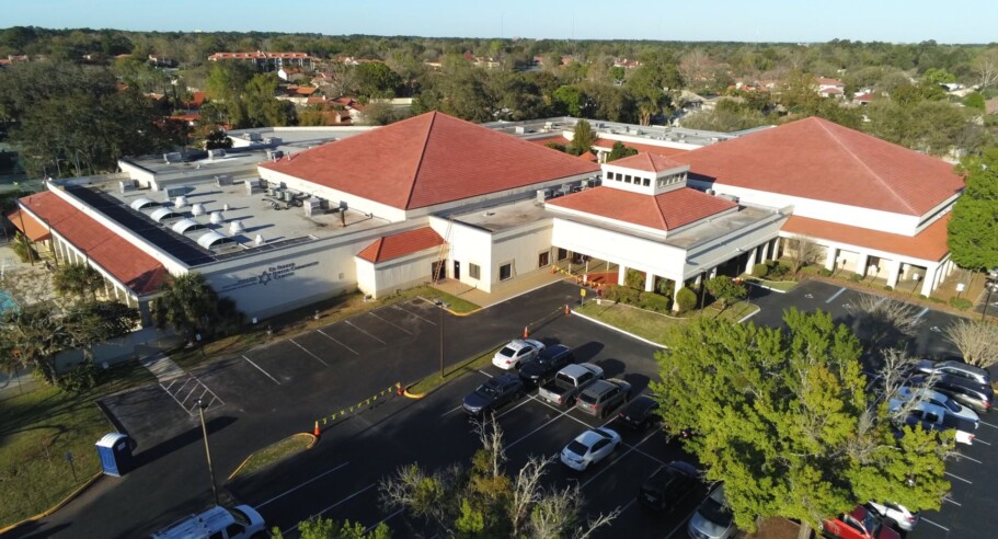 An aerial view of a parking lot and a building.