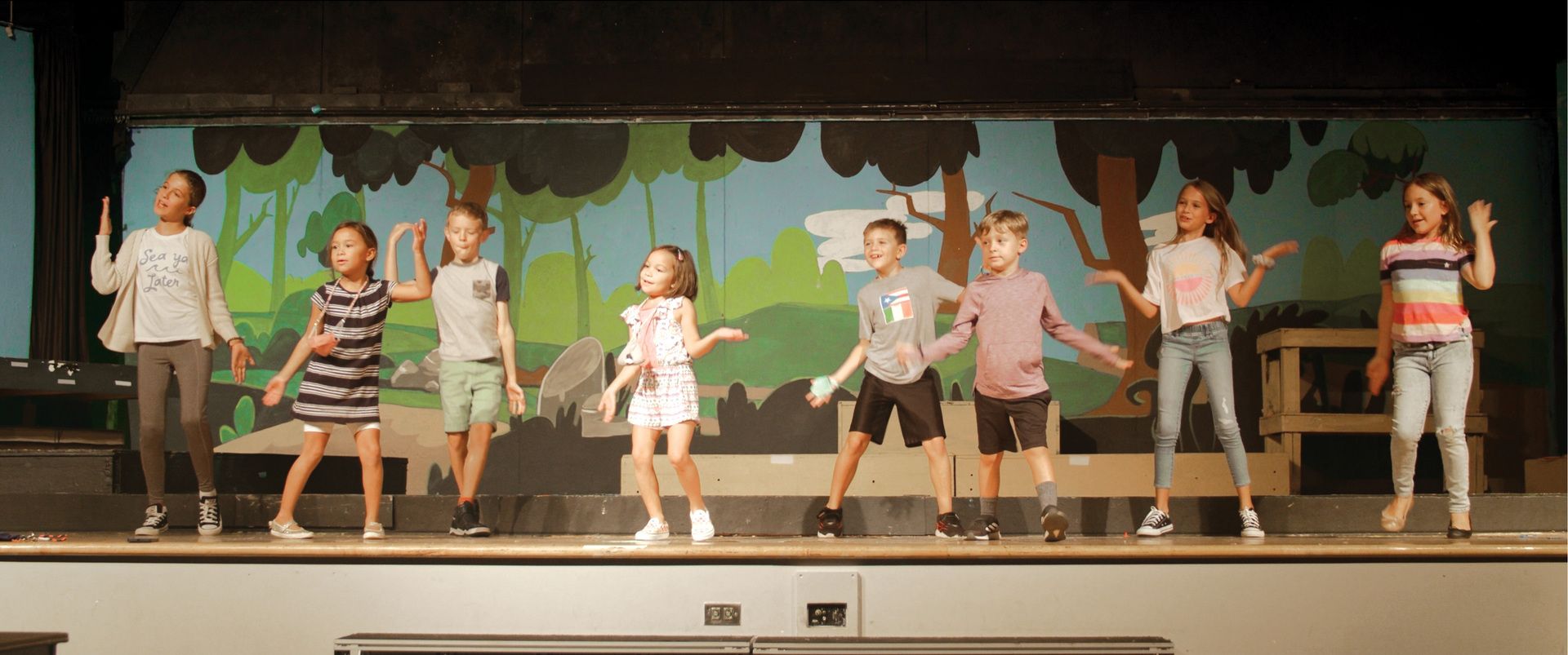 A group of children standing on a stage.