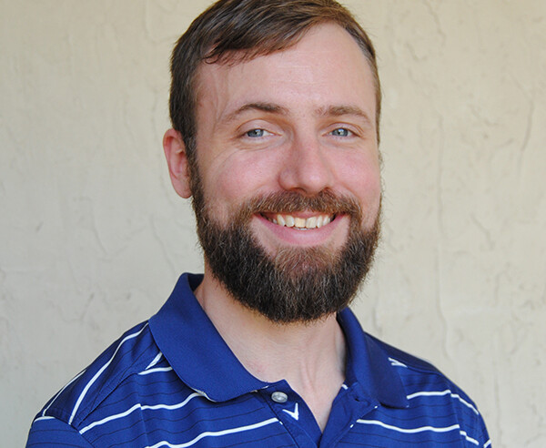 A man wearing a blue and white striped shirt.