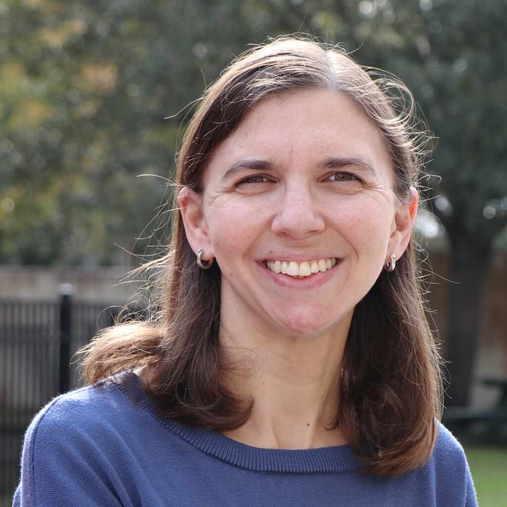 A woman wearing a blue shirt.