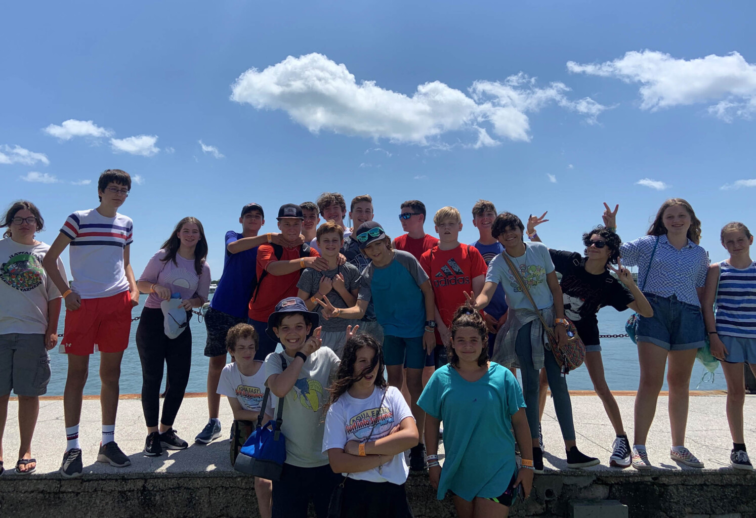 Group of teens at the beach together.