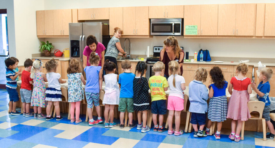 Young children learning how to cook.