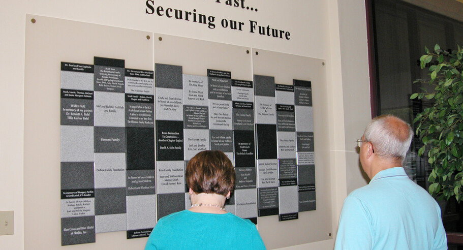 A man and a woman looking at a wall display.