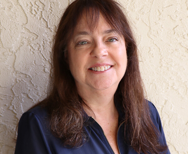 A woman wearing a blue shirt.