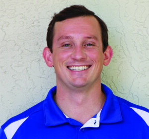 A man wearing a blue and white polo shirt.