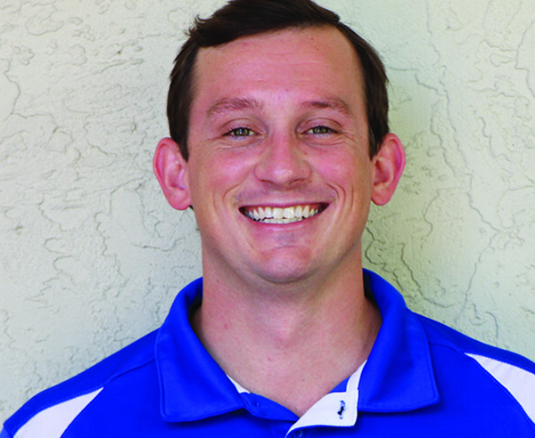 A man wearing a blue and white polo shirt.