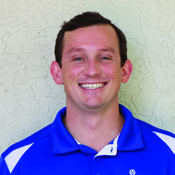 A man wearing a blue and white polo shirt.