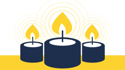 Three burning candles on a yellow background.