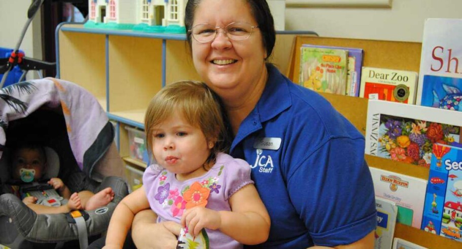 caretaker holding toddler.