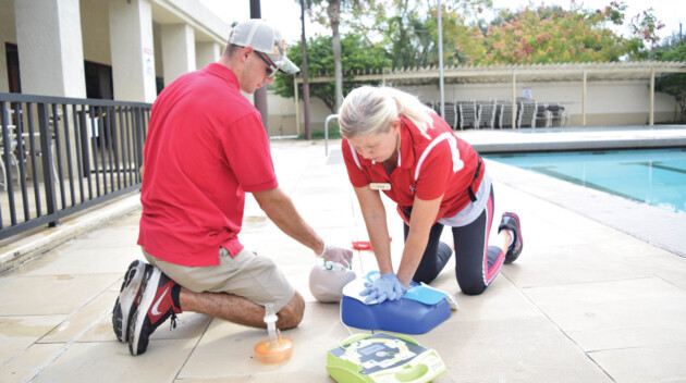 Two people training how to do CPR.