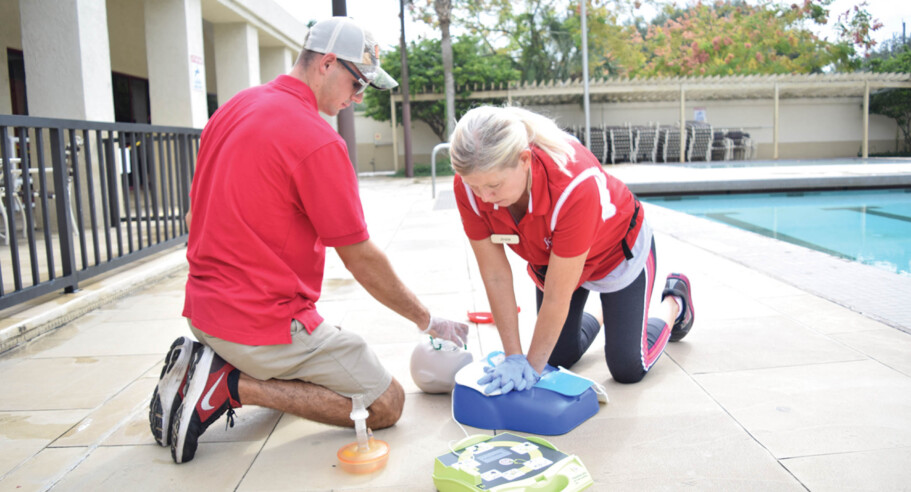 Two people training how to do CPR.