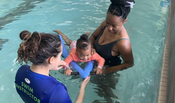 Mom and baby with swim instructor during Parent and Me Learn to Swim Lessons