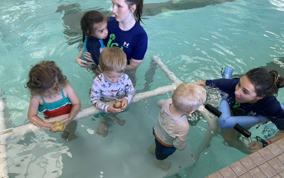 A group of children in an indoor swimming pool.