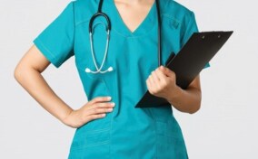 A female nurse holding a clipboard.