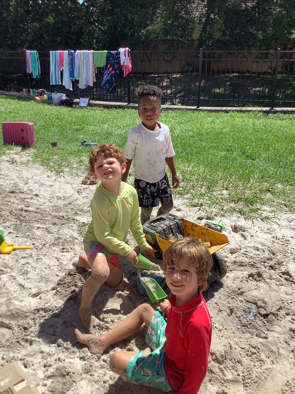 A group of children playing in the sand.