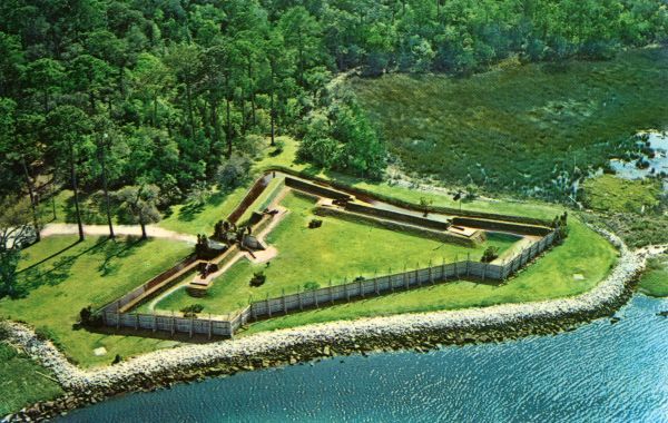 An aerial view of a fort near the water.
