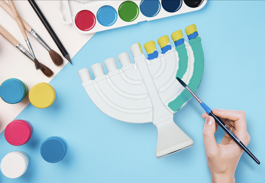 A person painting a hanukkah menorah.