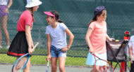 Girl laughing playing tennis in Camp Kaytana