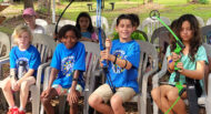 Boys smiling during their archery specialty during Camp Habonim