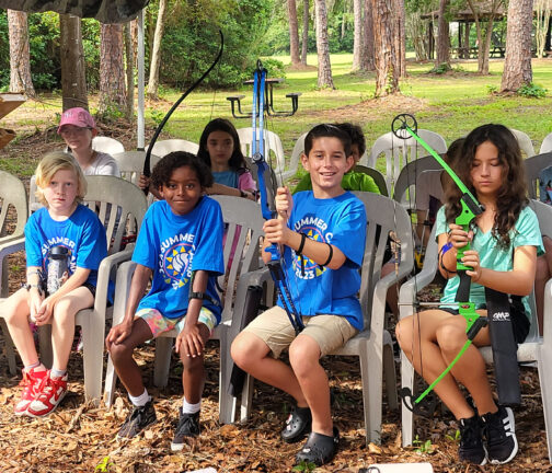 Boys smiling during their archery specialty during Camp Habonim