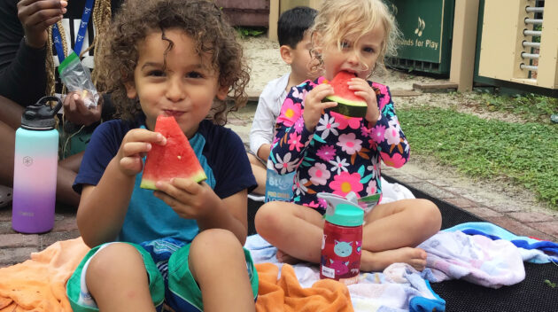 K'ton campers eating watermelon outside after water play