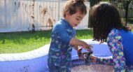 Boy and girl playing in mud for International Mud Day in Camp Pattycakes