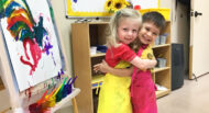 A girl and boy hug after painting in Camp Tovim