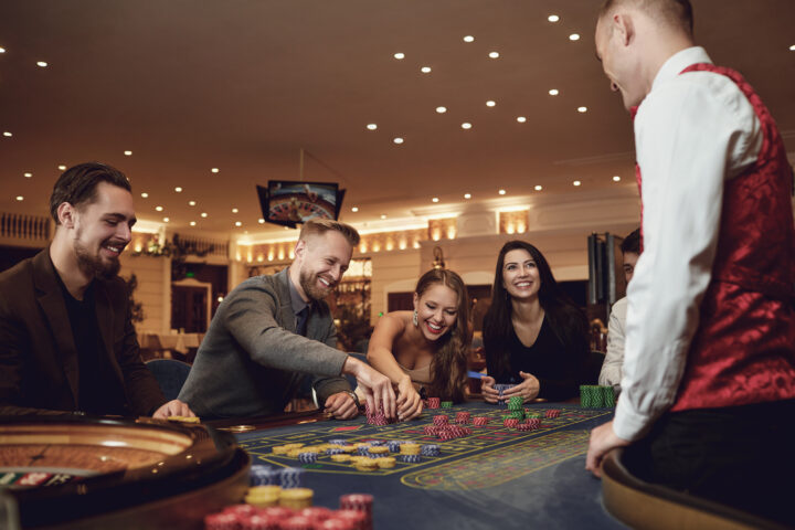 Happy people are betting at roulette