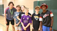 A group of boys posing for a picture in a gym.