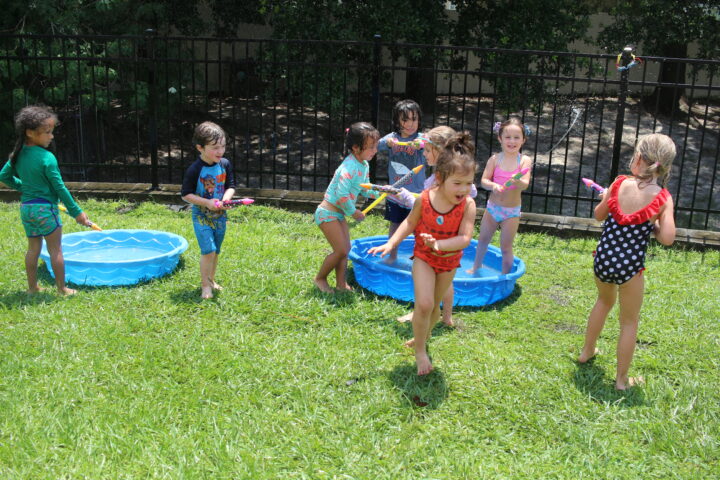 A group of children playing in a pool.