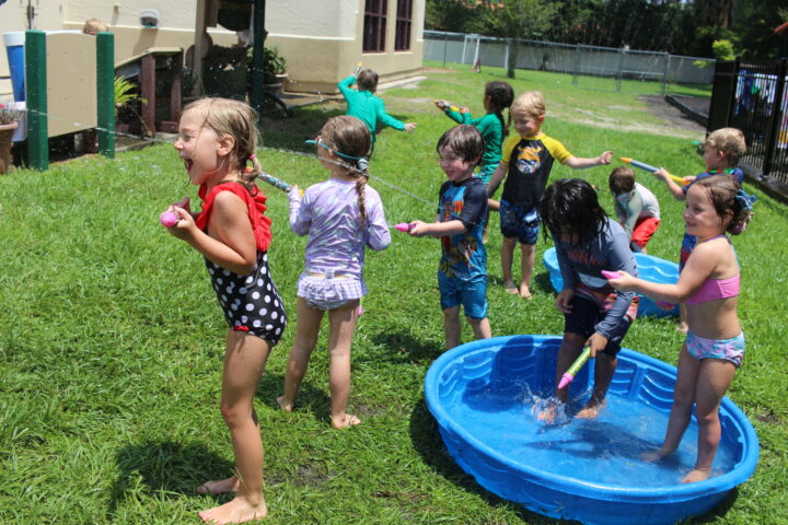 A group of children playing in a pool.