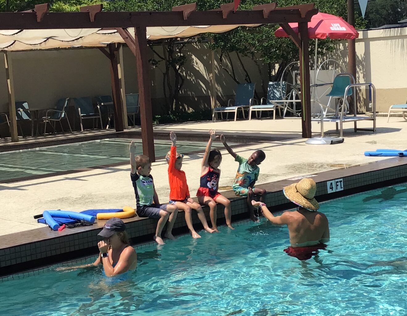 A group of children playing in a swimming pool.