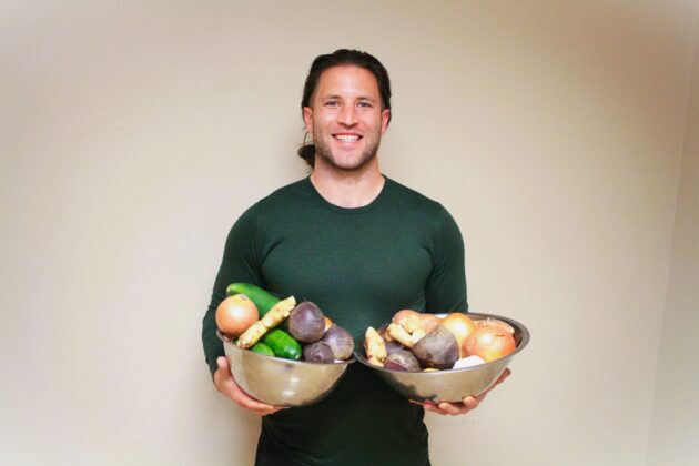 Grant Helm holding bowls of vegetables for Soup Yoga.