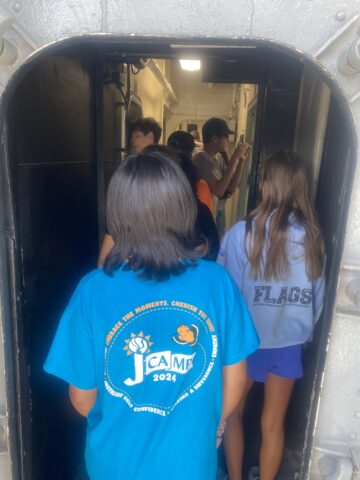 A group of people walking through a doorway.