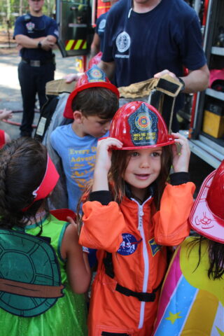 A child wearing a firefighter hat.