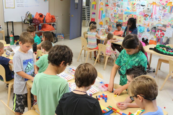 A group of children are working on a project in a classroom.