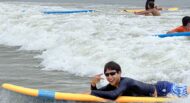 A group of people riding surfboards in the ocean.