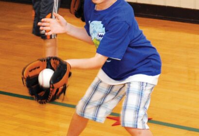 A young boy wearing a baseball mitt.