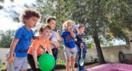 A group of children standing on top of a playground.