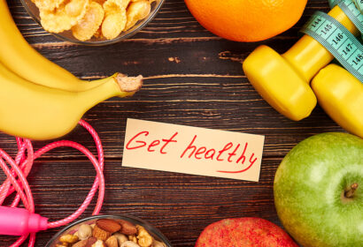 A group of food and work out items with a note in the middle saying "Get healthy".