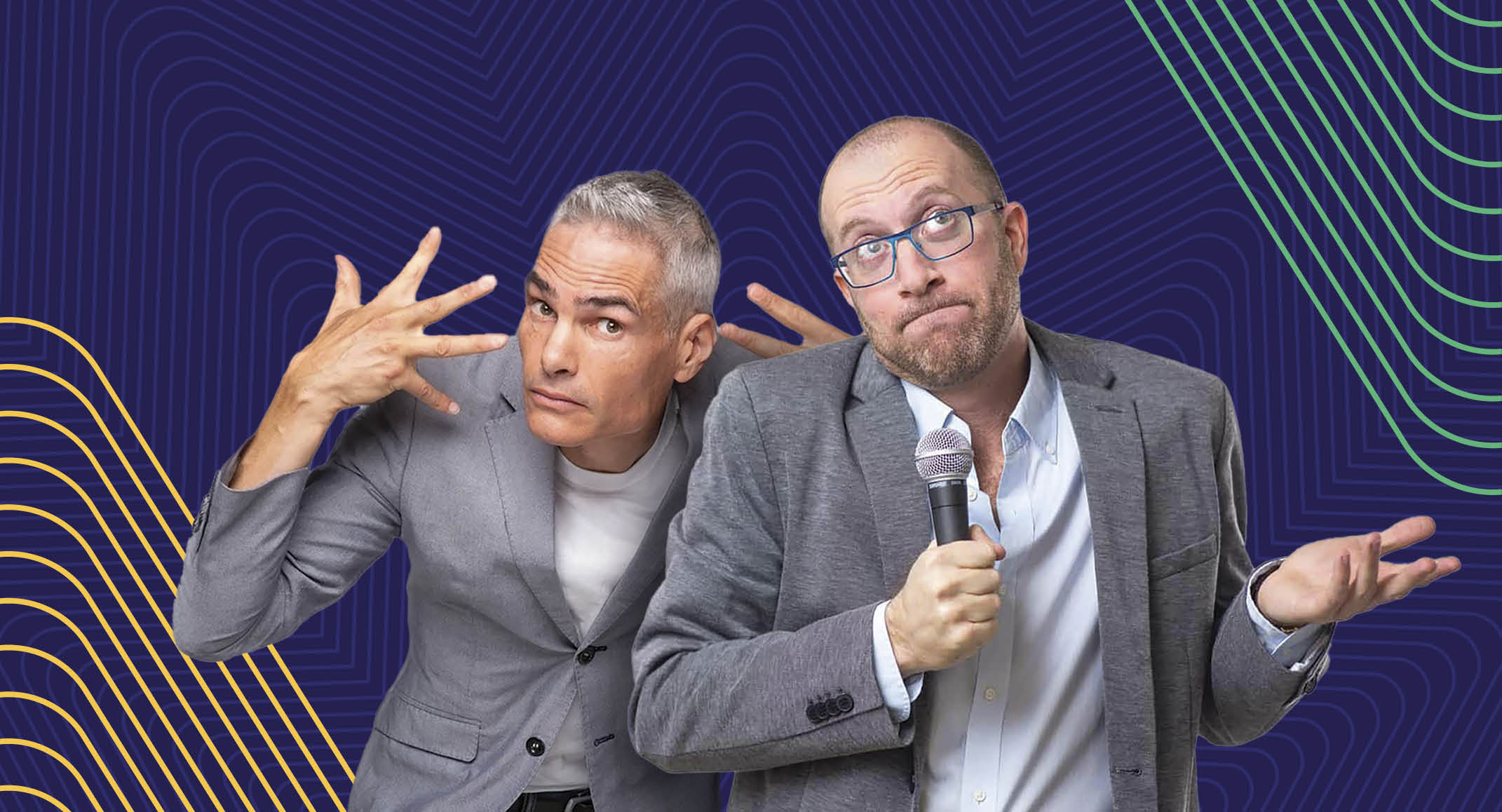 Two men in gray blazers stand in front of a blue background with geometric patterns. One man gestures animatedly with his hands, while the other holds a microphone and gestures with a shrug.