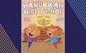 Cover of the book "Hanukkah Hippity-Hop" featuring two children dancing joyfully in front of a lit menorah, written by Barbara Kimmel and illustrated by Ana Zurita.