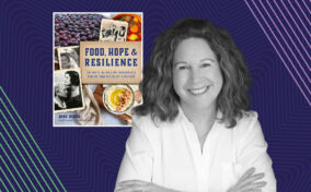 A woman stands with arms crossed in front of a book titled "Food, Hope & Resilience: Authentic Recipes and Remarkable Stories from Appalachian Homesteads" by June Weber.