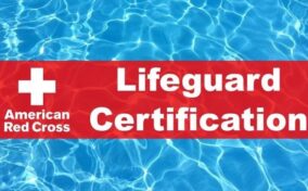 Red banner with "American Red Cross Lifeguard Certification" text over a background of blue swimming pool water.