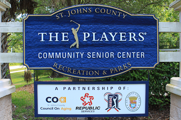 Sign for St. Johns County The Players Community Senior Center, showcasing partnerships with CoA, Republic Services, PGA Tour, and St. Johns County Recreation & Parks.