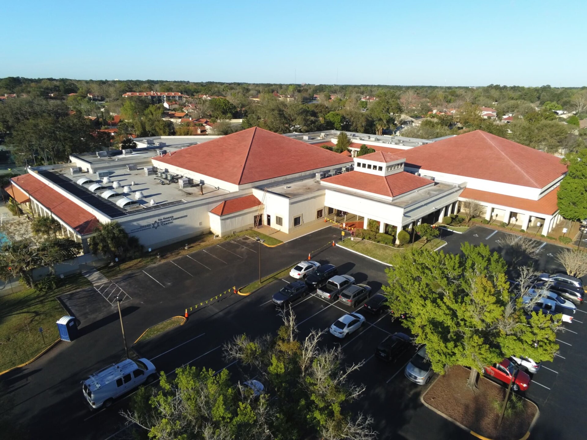 An aerial view of a parking lot and a building.