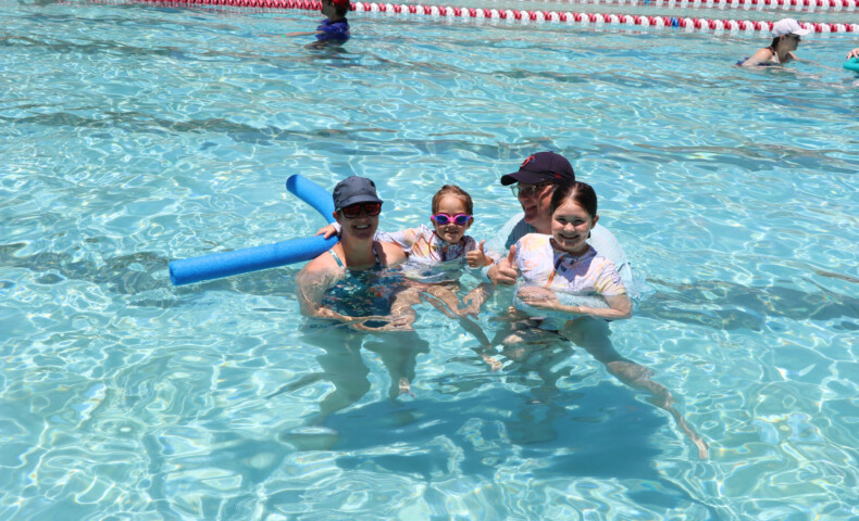 Kids with parents in pool.