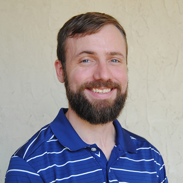 A man wearing a blue and white striped shirt.